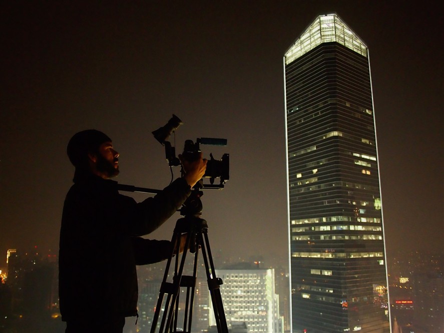 Guangzhou filming crew at night with city lights in the background