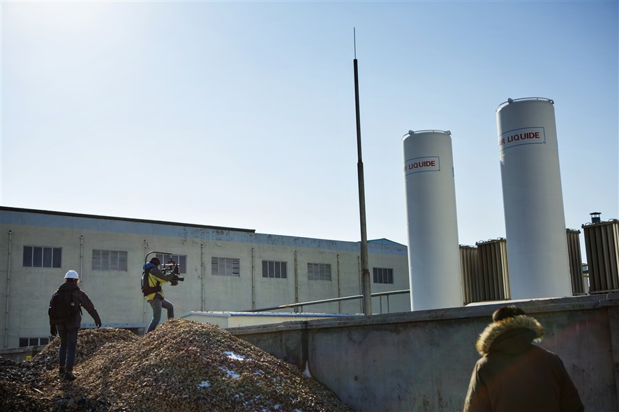 Guangzhou production crew coordinating a shoot in an industrial location